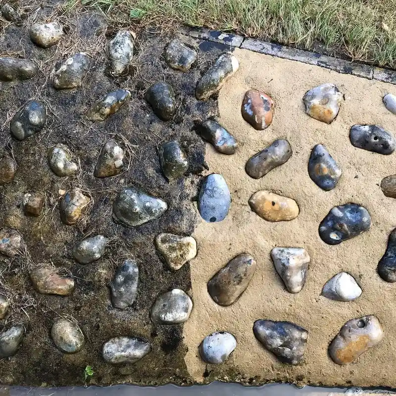 A pebble surface with one part cleaned and the rest still dirty